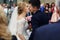 Happy beautiful blonde bride kissing handsome smiling groom close-up