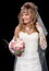 Happy beautiful bride on black background with bouquet of wedding flowers