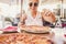 Happy beautiful caucasian lady enjoying a big italian tasty pizza at the restaurant pizzeria sitting outdoor - Cheerful people