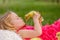 Happy beautiful child, kid, playing with beautiful ducklings or goslings, cute fluffy yellow animal birds