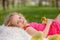 Happy beautiful child, kid, playing with beautiful ducklings or goslings, cute fluffy yellow animal birds