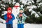 Happy beautiful children, brothers, building snowman in garden