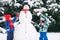 Happy beautiful children, brothers, building snowman in garden a