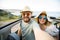 Happy beautiful couple in love taking a selfie portrait driving a convertible car on the road at vacation. Rental cars