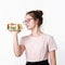 Happy beautiful cute teen girl in glasses and t-shirt with smile on face holding plate of cakes on white background