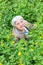 Happy beautiful elderly woman sitting on a glade