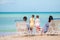 Happy beautiful family of four on the beach.