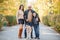 Happy beautiful family walking with dog in the park. Animal concept.