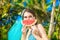 Happy beautiful girl with slice of watermelon on the beach of a