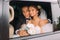 Happy beautiful groom and bride with bridal bouquet, hairstyle in car