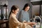 Happy beautiful mother and daughter smiling and washing dishes