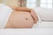 Happy Beautiful Pregnant Asian Woman lying on bed smile and sleep with big belly so comfortable and relax,Pregnancy of young woman