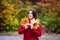 Happy beautiful woman in autumn, cute plus size model in red sweater outdoors