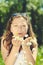 Happy beautiful woman blowing dandelion over