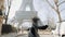 Happy beautiful woman excited to see famous Eiffel Tower in Paris, spinning cheerfully. Wanderlust concept slow motion.