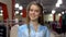 Happy beautiful woman portrait stands at shop. Attractive caucasian girl smile in big mall