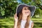Happy beautiful woman in stylish hat outside laughing