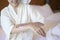 Happy beautiful woman in white bathrobe applying body moisturizing cream in bedroom, skin care and treatment concept