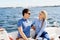 Happy and beautiful young couple having a rest on a yacht. Traveling, tourism, journey, concept.