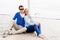 Happy and beautiful young couple sitting on deck and having a good time together. Traveling, tourism, journey, concept.