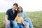 Happy beautiful young family posing outdoors