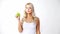 Happy beautiful young woman eating green apple