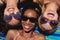 Happy beautiful young women with sunglasses lying on beach in the sunshine