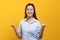 Happy beauty asian young woman showing excite expression.  Shot in studio isolated on yellow background