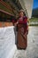 A happy Bhutanese lady rolling the prayer wheels , Chorten Kora stupa , Trashiyangtse District , eastern Bhutan