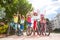 Happy bicycle riders standing in city park