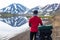 Happy biker on backdrop of lake and snowing mountains in Iceland