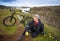 Happy biker on backdrop of waterfall in mountains Iceland