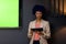 Happy biracial casual businesswoman with blue afro making presentation with tablet, copy space