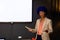 Happy biracial casual businesswoman with blue afro making presentation at whiteboard with copy space