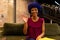 Happy biracial casual businesswoman with blue afro making video call, waving in office