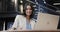 Happy biracial casual businesswoman making video call using laptop in office lounge, slow motion