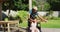 Happy biracial couple dancing on terrace in garden, woman in wheelchair, man with dreadlocks