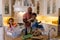 Happy biracial father, son and daughter sorting rubbish for recycling into boxes on kitchen counter