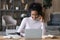 Happy biracial female student study distant on laptop