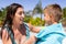 Happy biracial mother and son using towel by the swimming pool