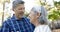 Happy biracial senior couple dancing in sunny garden