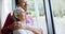 Happy biracial senior couple embracing at window at home