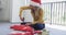 Happy biracial woman wearing santa hat packing christmas presents, slow motion