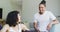 Happy biracial woman in wheelchair and male partner looking at each other and smiling in living room