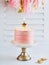 Happy birthday cake shot on a white light background with golden stars candles and space for text. Romantic Celebration Party