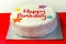 Happy Birthday Cake, Sponge cake layered with a sweet frosting and raspberry jam, decorated with soft icing decorations