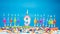 Happy birthday candle letters with number nine on a beautiful blue background. Copy space Happy birthday greetings for 9 years old