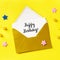 Happy Birthday card in a golden envelope, overhead square shot on a yellow background