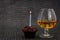 Happy birthday Chocolate maffin on gray background with candle and glass cognac and English money