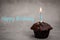 Happy birthday Chocolate maffin on gray background with candle and glass cognac and English money